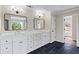 Bright main bathroom with double vanity and sinks, and dark tile floors at 410 Hickory Fairway Ct, Woodstock, GA 30188