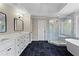 Elegant main bathroom featuring double vanity, large shower, and soaking tub at 410 Hickory Fairway Ct, Woodstock, GA 30188