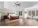Serene main bedroom with tray ceilings, sitting area, and hardwood floors at 410 Hickory Fairway Ct, Woodstock, GA 30188