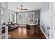 Well-lit home office with a leather couch, desk, and many windows providing ample natural light at 410 Hickory Fairway Ct, Woodstock, GA 30188