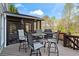 Enjoy outdoor dining on the expansive deck with screened porch and grill; perfect for entertaining at 410 Hickory Fairway Ct, Woodstock, GA 30188