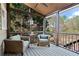 Relaxing screened porch with ceiling fan and comfortable seating overlooking picturesque backyard views at 410 Hickory Fairway Ct, Woodstock, GA 30188