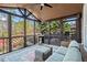Inviting screened porch featuring a ceiling fan and wicker furniture with views of outdoor patio at 410 Hickory Fairway Ct, Woodstock, GA 30188