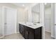Bathroom with double vanity, dark wood cabinets, and tile flooring at 4798 Red Lion Pl, Lawrenceville, GA 30044