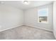 Simple, carpeted bedroom with natural light from the window at 4798 Red Lion Pl, Lawrenceville, GA 30044