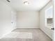Bright bedroom with neutral carpet, a window with blinds, and a closet at 4798 Red Lion Pl, Lawrenceville, GA 30044