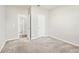 Carpeted bedroom features an open door leading to the bathroom at 4798 Red Lion Pl, Lawrenceville, GA 30044