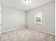 Bedroom with neutral carpet, natural light, and a bright window at 4798 Red Lion Pl, Lawrenceville, GA 30044