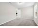 Bright carpeted bedroom with a view into the laundry room at 4798 Red Lion Pl, Lawrenceville, GA 30044