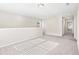 Neutral upstairs bonus room with natural light and a view down the hallway at 4798 Red Lion Pl, Lawrenceville, GA 30044