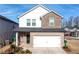 Charming two-story home with a brick and stone facade and a two-car garage at 4798 Red Lion Pl, Lawrenceville, GA 30044