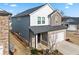 Beautiful two-story home with a combination of siding, stone accents and a two-car garage at 4798 Red Lion Pl, Lawrenceville, GA 30044