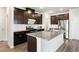 Bright kitchen featuring a large island, stainless steel appliances, and dark wood cabinets at 4798 Red Lion Pl, Lawrenceville, GA 30044