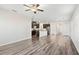 Open-concept living room flows into the kitchen with wood-look floors and lots of natural light at 4798 Red Lion Pl, Lawrenceville, GA 30044
