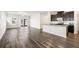 Open-concept living area with hardwood floors, kitchen and sliding glass doors at 4798 Red Lion Pl, Lawrenceville, GA 30044