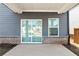 Covered patio featuring concrete flooring, brick border, siding and double glass doors at 4798 Red Lion Pl, Lawrenceville, GA 30044