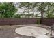 Backyard featuring a round patio and fence for privacy and outdoor enjoyment at 505 Mirror Lake Pkwy, Villa Rica, GA 30180