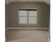 Bedroom featuring neutral walls and carpet, with a window allowing natural light at 505 Mirror Lake Pkwy, Villa Rica, GA 30180