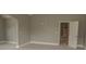 A neutral bedroom featuring an open doorway leading to another room at 505 Mirror Lake Pkwy, Villa Rica, GA 30180