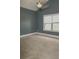 Cozy bedroom with a ceiling fan and ample natural light streaming through a large window at 505 Mirror Lake Pkwy, Villa Rica, GA 30180