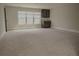 Expansive bonus room featuring plush carpeting, natural light, and a stylish wet bar area perfect for entertaining at 505 Mirror Lake Pkwy, Villa Rica, GA 30180