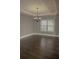Elegant dining area with hardwood floors, neutral walls, and a stylish chandelier at 505 Mirror Lake Pkwy, Villa Rica, GA 30180