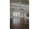 Bright living area with hardwood floors, stone fireplace, and coffered ceiling at 505 Mirror Lake Pkwy, Villa Rica, GA 30180
