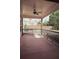 Cozy porch area with fan and outdoor view of the fenced in yard at 505 Mirror Lake Pkwy, Villa Rica, GA 30180