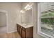 Bathroom with double sink vanity and window overlooking lake at 559 Myrle Trace Ln, Suwanee, GA 30024