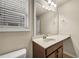 Bathroom featuring a wooden vanity, white sink, and a large mirror at 559 Myrle Trace Ln, Suwanee, GA 30024