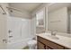 Bright bathroom featuring a shower-tub, window, and vanity with a sink at 559 Myrle Trace Ln, Suwanee, GA 30024