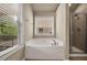 Soaking tub with a beautiful view from the window with privacy blinds at 559 Myrle Trace Ln, Suwanee, GA 30024