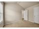A carpeted bedroom featuring white base molding, a window, and two entry doors for privacy at 559 Myrle Trace Ln, Suwanee, GA 30024