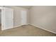 Carpeted bedroom with a neutral color scheme featuring two entry doors and base molding at 559 Myrle Trace Ln, Suwanee, GA 30024