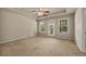 Bright bedroom with trey ceilings, ceiling fan, and access to balcony with wooded view at 559 Myrle Trace Ln, Suwanee, GA 30024