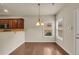 Bright dining area features hardwood floors, modern lighting, and neutral paint colors at 559 Myrle Trace Ln, Suwanee, GA 30024