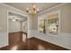 Dining room with hardwood floors, wainscoting and view to the front yard and living room at 559 Myrle Trace Ln, Suwanee, GA 30024