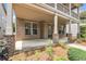 Inviting front porch featuring brick columns and ample space for relaxing, complemented by charming landscaping at 559 Myrle Trace Ln, Suwanee, GA 30024