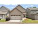 A two-car attached garage showcasing its overhead door in a well-maintained exterior, blending functionality with curb appeal at 559 Myrle Trace Ln, Suwanee, GA 30024