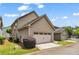 Spacious two-car attached garage with its overhead door adding practical convenience to the home's attractive exterior at 559 Myrle Trace Ln, Suwanee, GA 30024