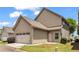 Attached two-car garage with stylish overhead door, seamlessly blending functionality and aesthetic appeal in a residential setting at 559 Myrle Trace Ln, Suwanee, GA 30024