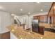 Modern kitchen with granite counters, stainless steel appliances, and ample cabinet space at 559 Myrle Trace Ln, Suwanee, GA 30024