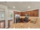 Well-lit kitchen with granite counters, stainless steel appliances, and plenty of cabinets at 559 Myrle Trace Ln, Suwanee, GA 30024