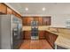 Modern kitchen featuring stainless steel appliances, granite countertops and dark wood cabinets at 559 Myrle Trace Ln, Suwanee, GA 30024
