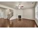 Spacious living room with hardwood floors, fireplace, ceiling fan and staircase at 559 Myrle Trace Ln, Suwanee, GA 30024