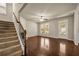 Open-concept living space with hardwood floors, lots of natural light and staircase at 559 Myrle Trace Ln, Suwanee, GA 30024