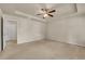 Main bedroom with neutral paint and carpet with doors to closet and bathroom at 559 Myrle Trace Ln, Suwanee, GA 30024