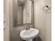 Classic pedestal sink with chrome faucet and framed mirror in powder room at 559 Myrle Trace Ln, Suwanee, GA 30024