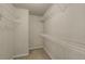 Spacious walk-in closet with neutral paint, carpeted flooring, and wire shelving for optimal storage and organization at 559 Myrle Trace Ln, Suwanee, GA 30024