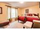 Comfortable bedroom with neutral colors, large window, and classic furnishings at 7101 Brecken Pl, Lithonia, GA 30058